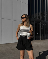 a lady wears a striped tank top with black loose fit shorts